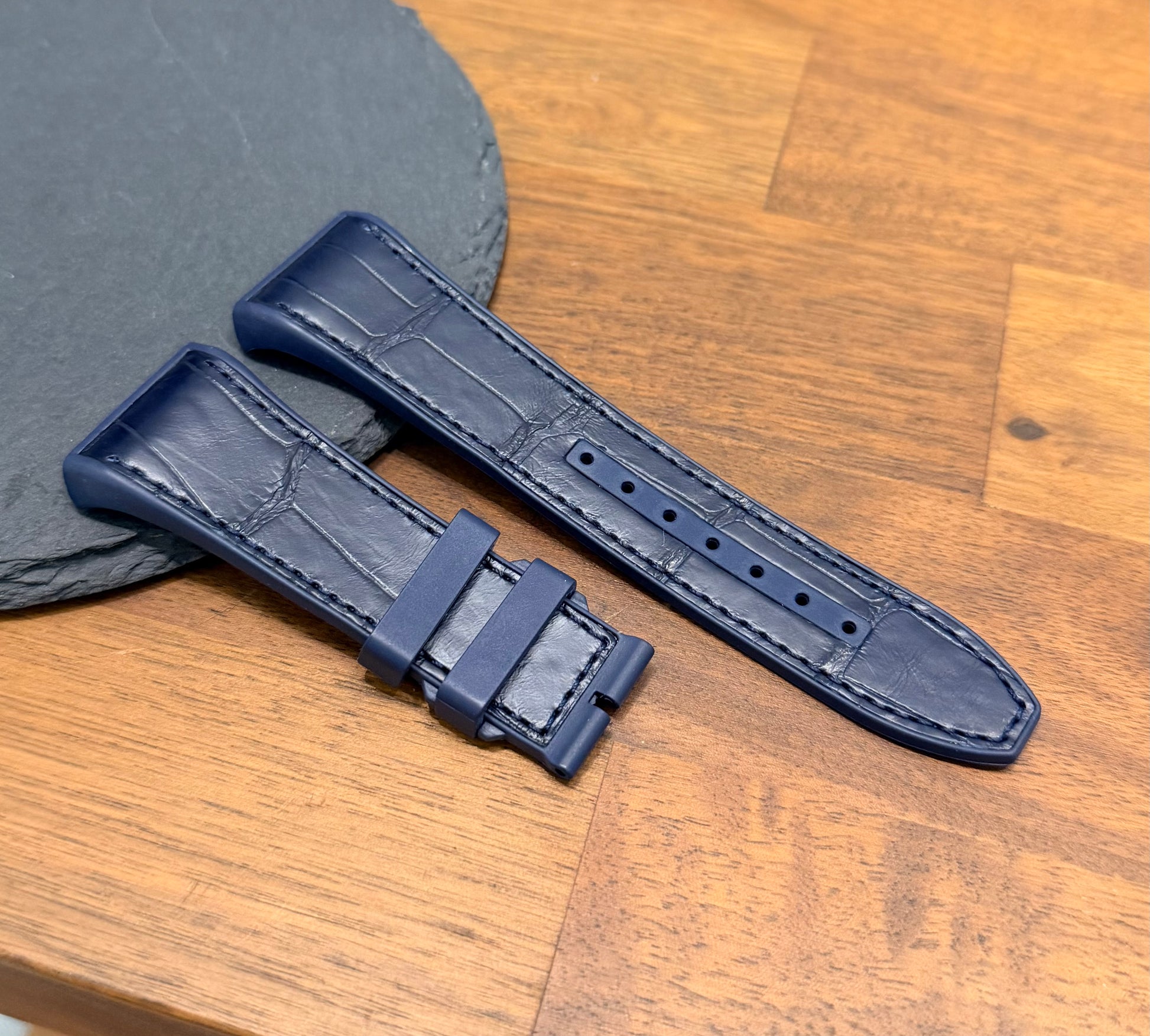 Navy blue Franck muller vanguard V45 alligator strap on wooden table surface 