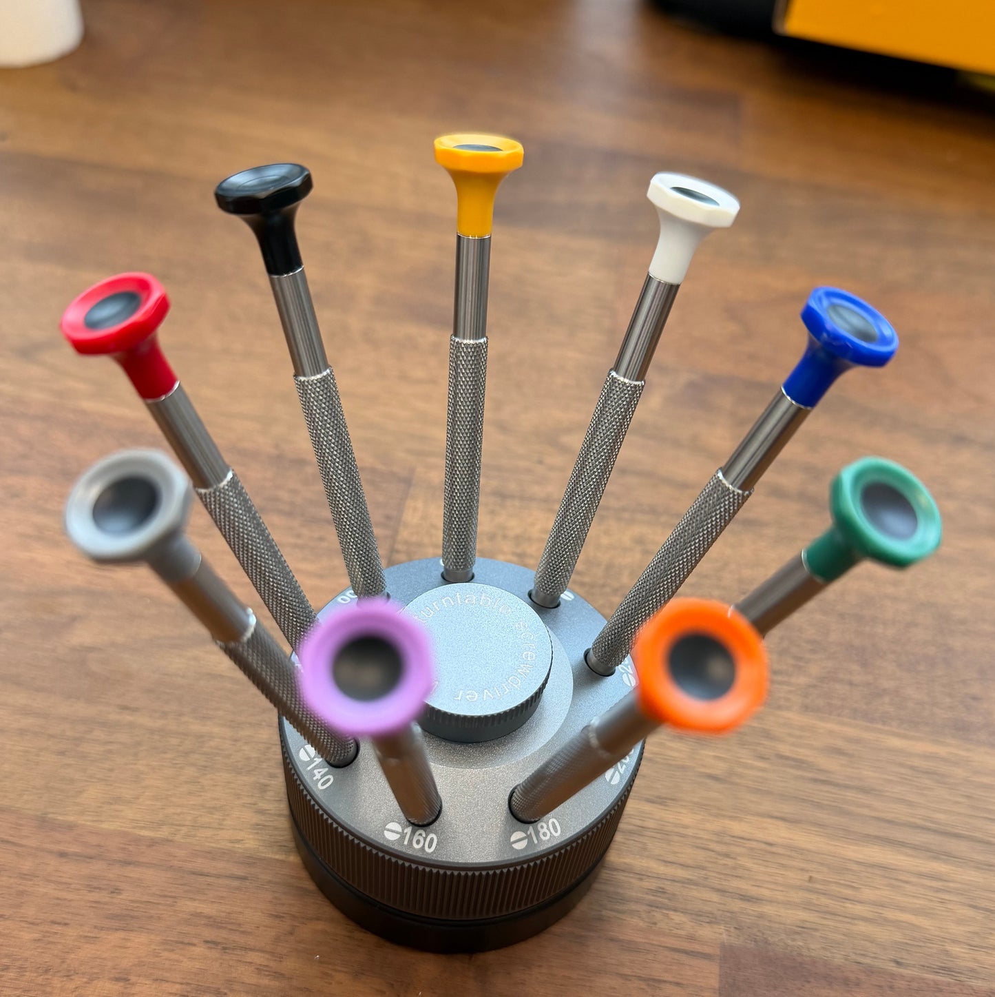 Set of screwdrivers with colored handles on a wooden surface