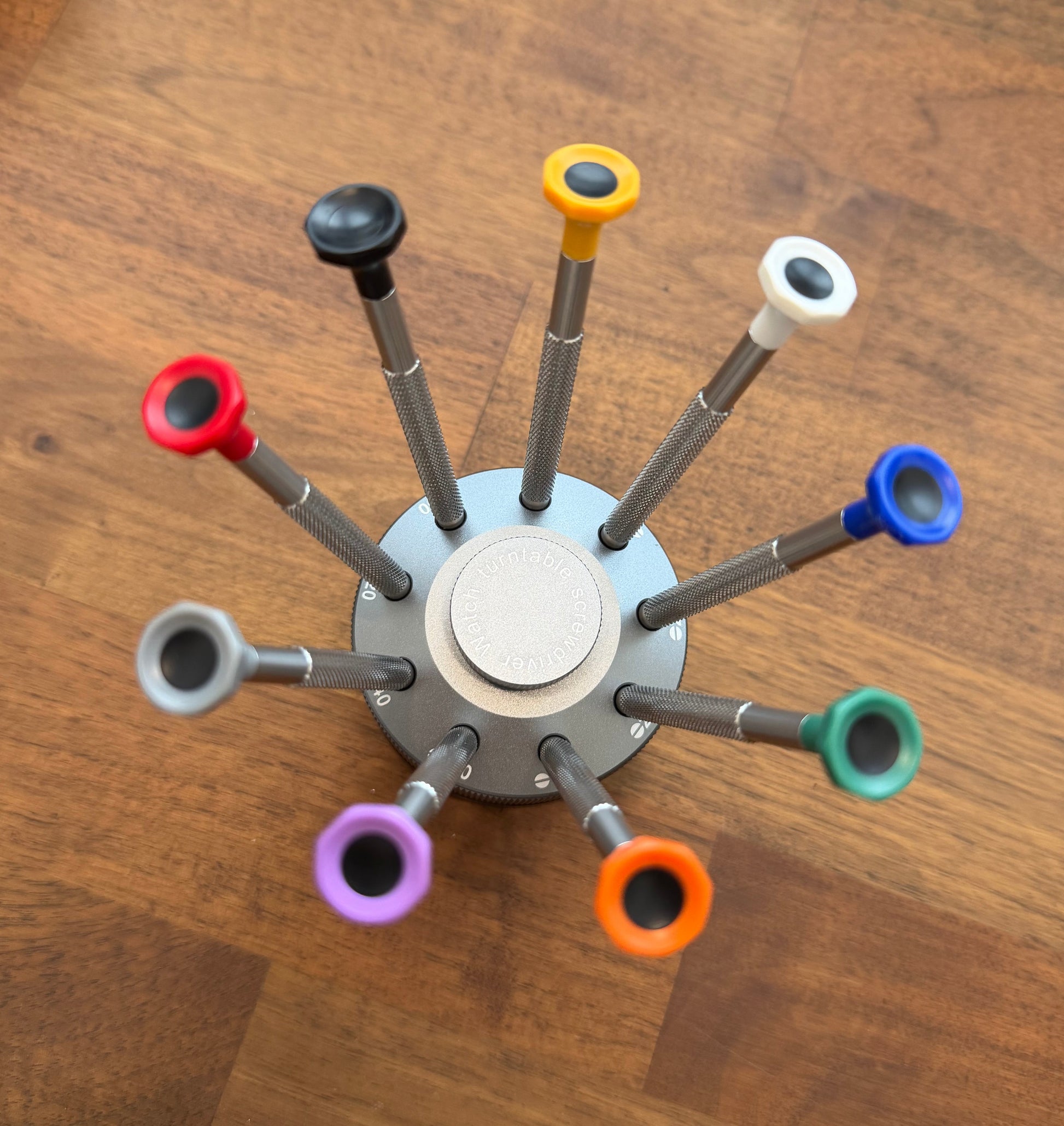 Colorful pen holder with multiple colored ends on a wooden surface high quality watch screwdriver set 