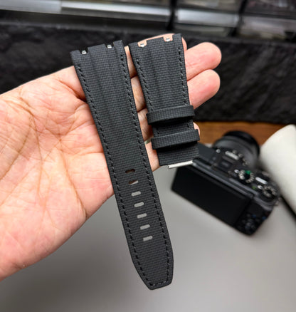 Black watch strap held in a hand with a blurred background sailcloth black for Audemars Piguet 26420 